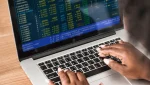 Hands typing in a laptop